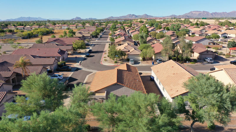 A suburb of houses in the Phoenix, Arizona area. The house in the center of the shot features an Erie Home Metal Roofing System.