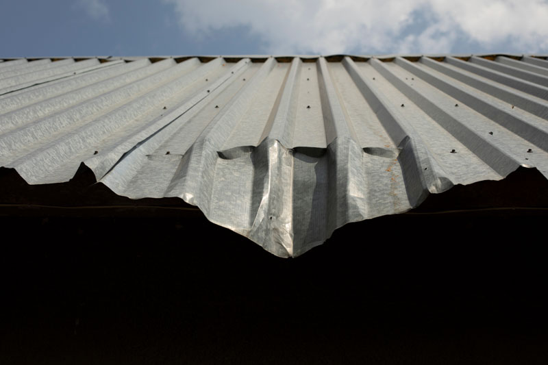 Dent on roof. Bent metal profile.