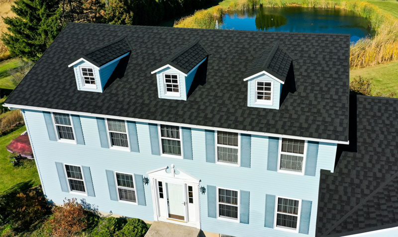 A Beautiful Erie Home Metal Roof featuring an Ironwood Granite Ridge Shingles