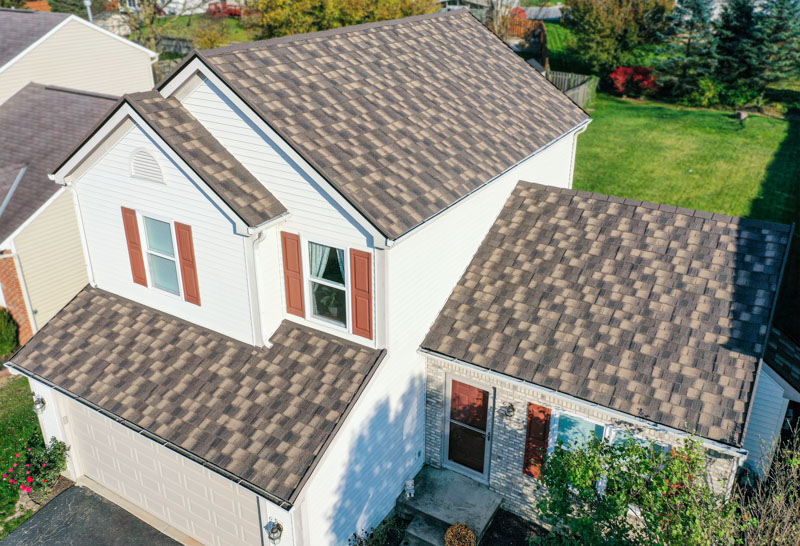 A Beautiful Erie Home Metal Roof featuring a Timberwood HD-Cottage Shingles