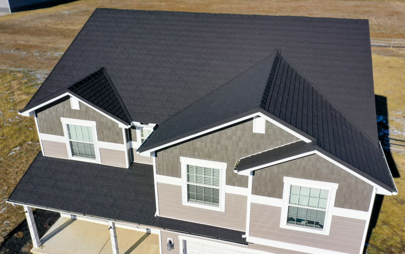 A Beautiful Erie Home Metal Roof featuring a Charcoal Granite Ridge Shingles