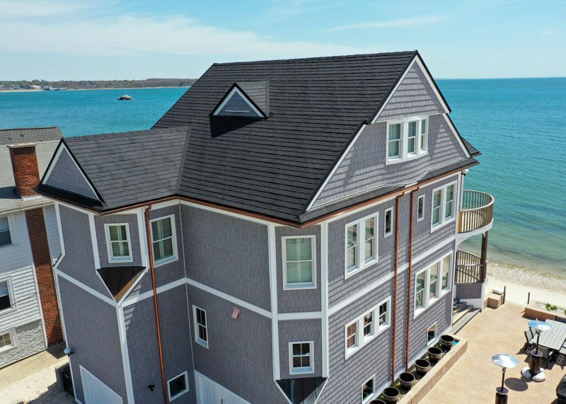 Beautiful metal roof featuring Erie Home metal shingles, with an ocean background.