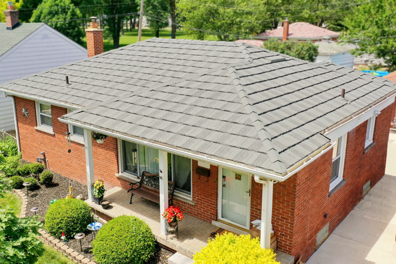 A Beautiful Erie Home Metal Roof featuring an Ironwood HD Pinecrest Roof.