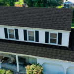 A Beautiful Erie Home Metal Roof featuring an Ironwood Pinecrest Roof.