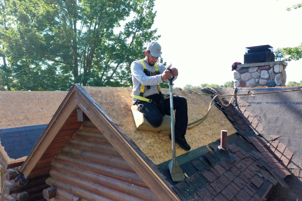 An Erie Home professional removes an old roof before installing a new Metal Roof