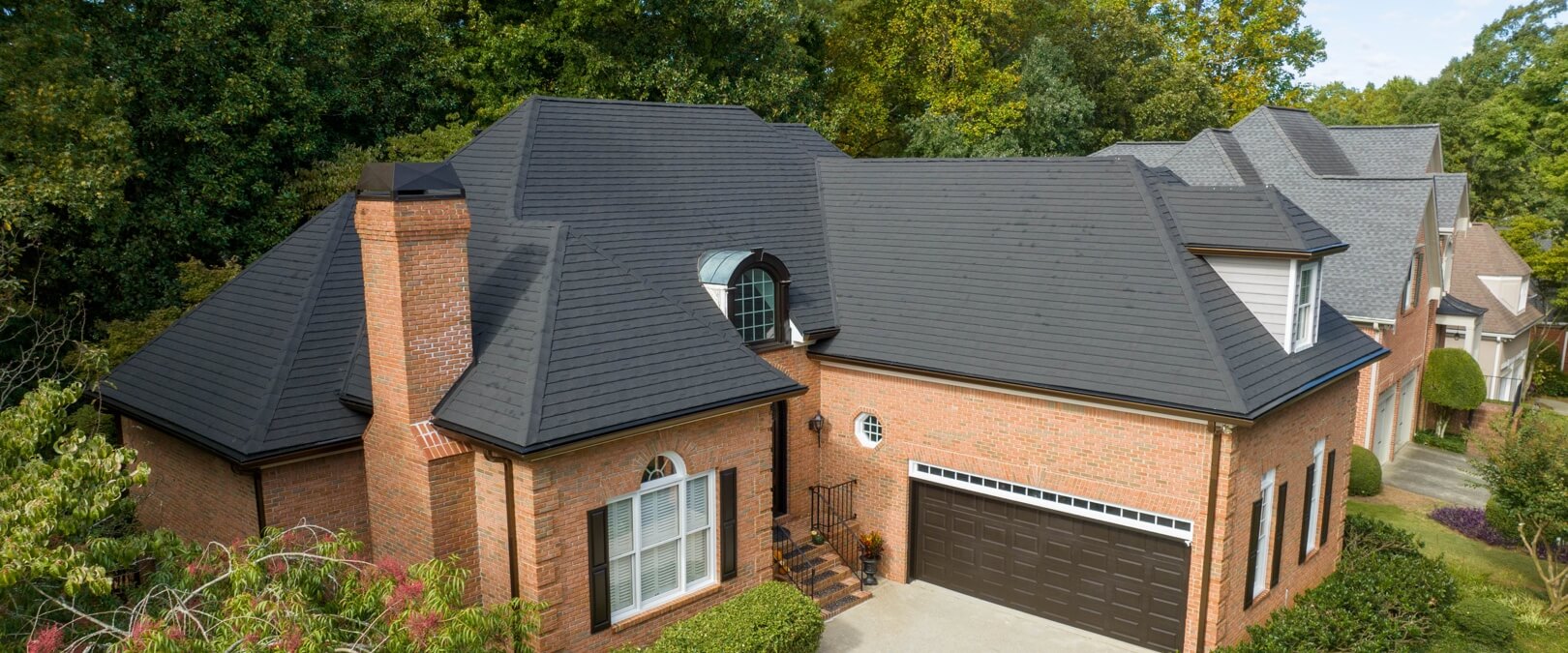 Red Brick Home with Metal Roof, Charcoal