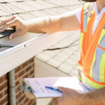 man inspecting a roof