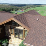 red metal roof in front of a green lanscape