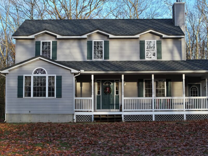 dark gray metal roof on light gray house