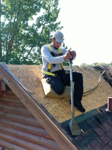 An Erie Home professional removes an old roof before installing a new Metal Roof