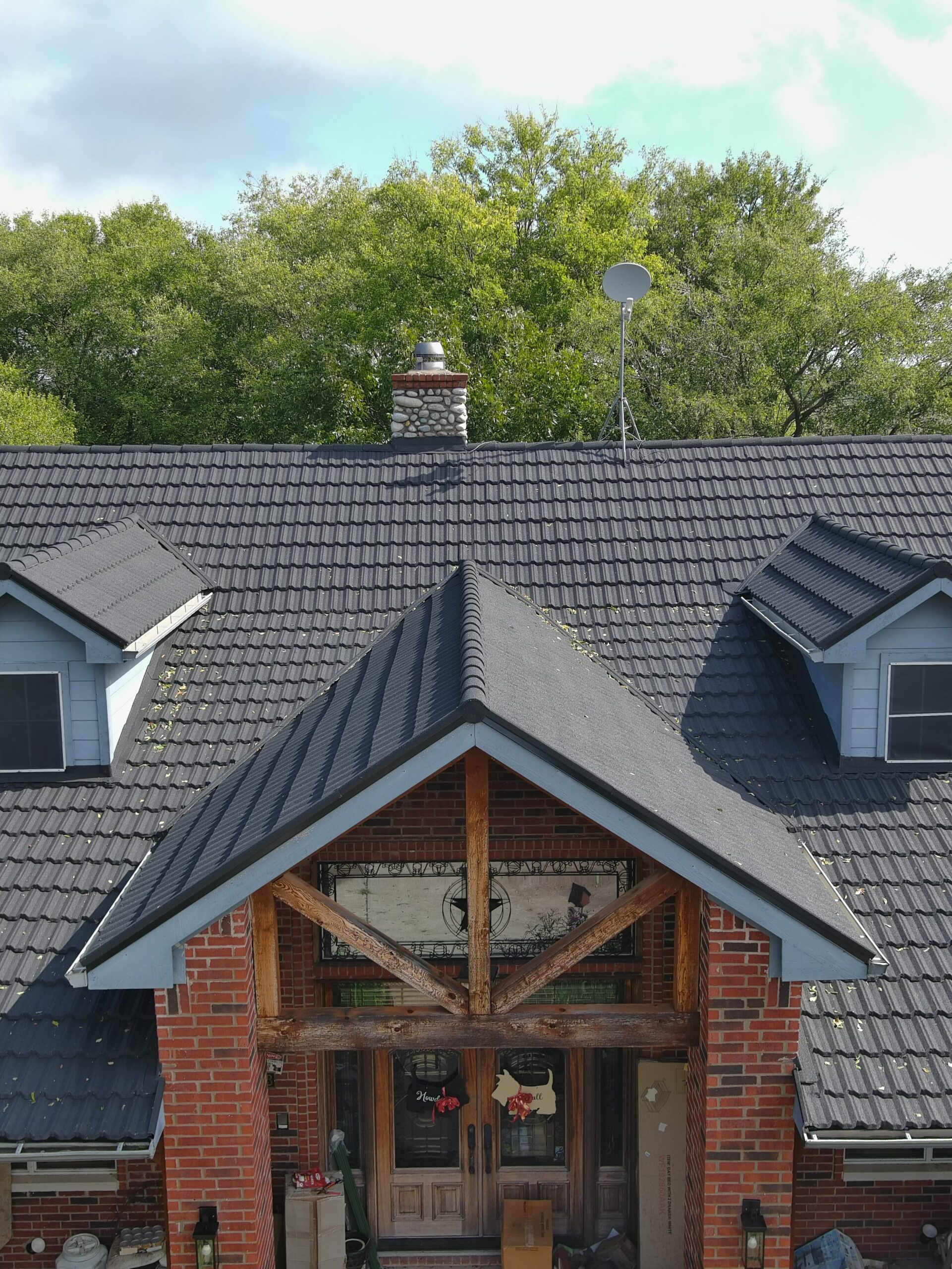 dark gray metal roof on brick home