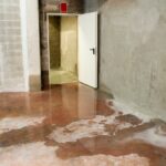 Cement wall basement moisture on floor from summer storm